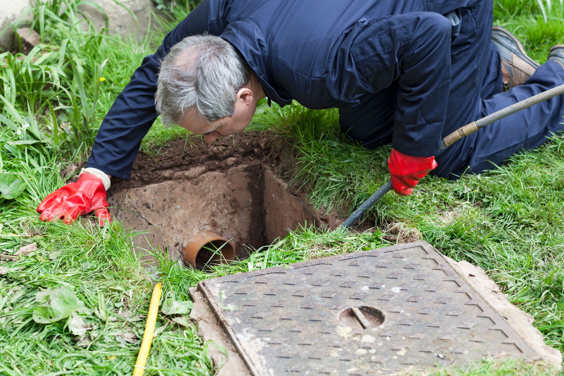 Man unblocking a drain